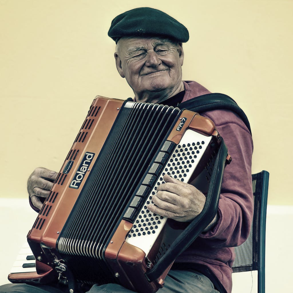 Man Sitting Playing Accordion